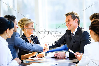 Mature businessman shaking hands to seal