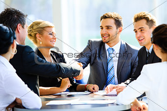 Mature businessman shaking hands to seal