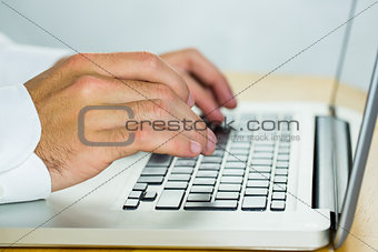 Man using laptop on desk