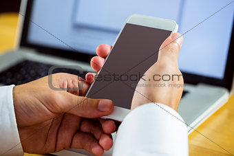 Man using laptop and smartphone