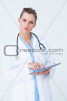Unsure doctor pointing tablet pc