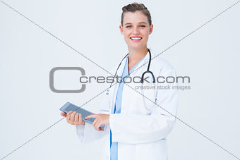 Happy doctor holding tablet pc