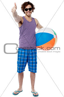 Cheerful guy giving thumbs up gesture