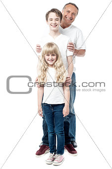 Smiling father with children standing in a row