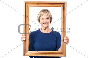 Middle aged lady holding photo frame