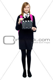 Cute school girl with a clapperboard