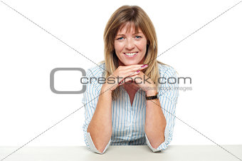 Smiling business lady sitting idle in office
