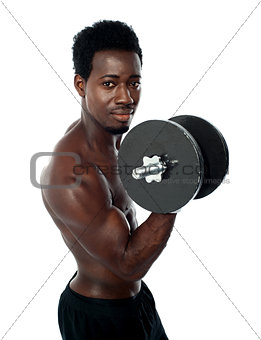 Muscular african guy doing biceps exercise