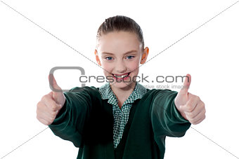 Little girl showing thumbs up to camera