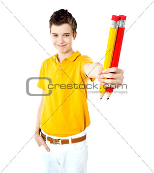 Stylish boy showing two large pencils
