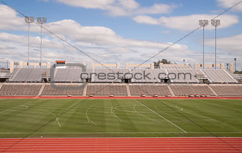 College Level Track Stadium Puffy Clouds Blue Sky