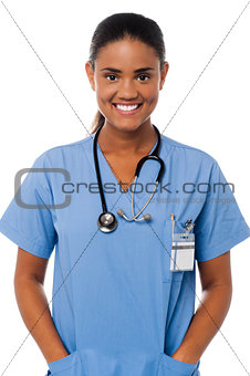 Young female doctor with hands in pocket