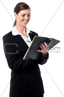 Corporate woman marking her schedule