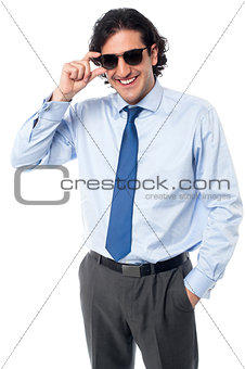 Handsome businessman adjusting sunglasses