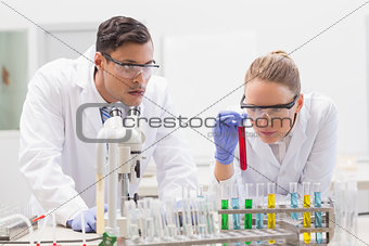 Scientists examining tubes