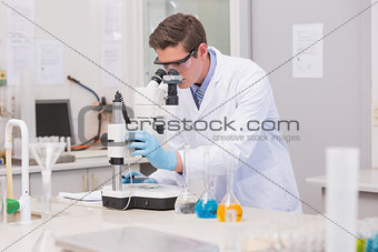 Scientist looking through a microscope