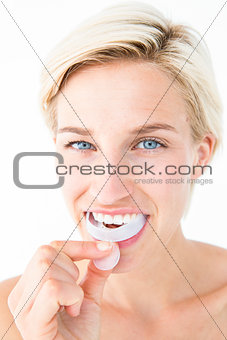 Happy woman putting her gum shield