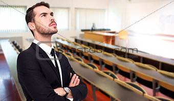 Composite image of thinking businessman with his arms crossed