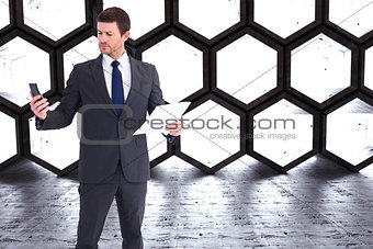 Composite image of businessman sending text holding page