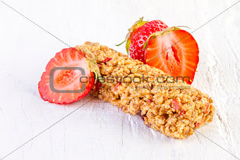 muesli bars with fresh strawberry on white wooden