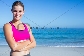 Fit blonde woman standing arms crossed