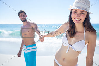 Smiling couple holding hands and looking at camera