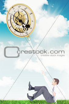 Composite image of businessman pulling a rope