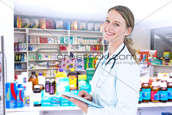 Composite image of doctor using tablet pc