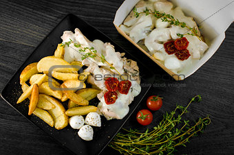 Delicious portion of rustic potatoes fillet with aromatic herbs