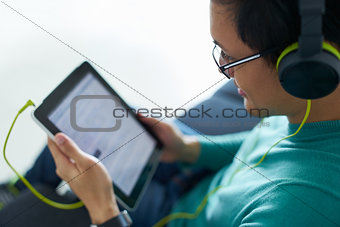 Chinese Man With Green Headphones Listens Podcast Tablet PC