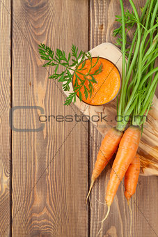 Fresh carrot juice smoothie and roots