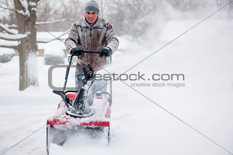 Man using snowblower in deep snow