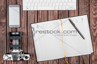 Notebook wit tablet on wooden table, top view