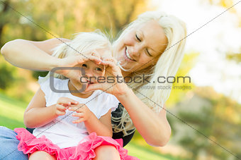 Little Girl With Mother Making Heart Shape with Hands