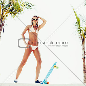 sexy suntanned lady is ready to go on penny board