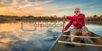 paddling canoe at sunset
