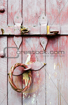 Old wooden door iron handle with lock