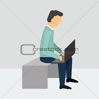 man sitting with a laptop in costume