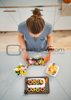 Woman in kitchen preparing halloween trick or treat