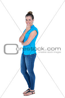 Happy pretty casual brunette looking at camera with hands on chin