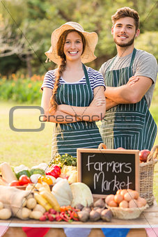 Happy farmers standing arms crossed