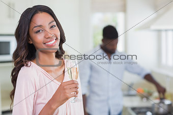 Happy woman having glass of champagne