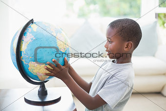 Little boy looking at the globe