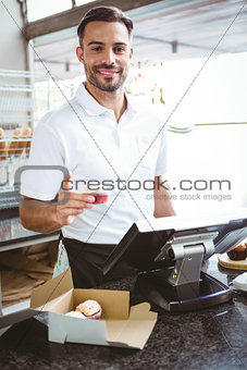Smiling worker prepares orders