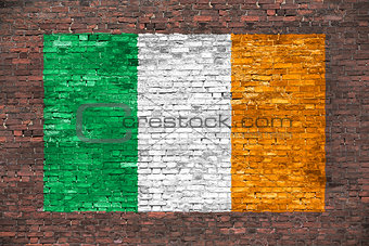 Flag of Ireland painted over brick wall