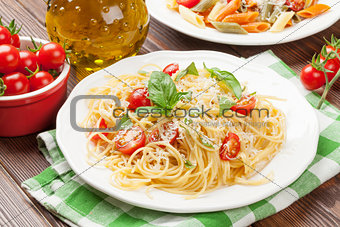 Spaghetti and penne pasta with tomatoes and basil