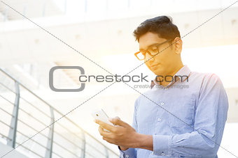 Indian business people browsing internet using smartphone