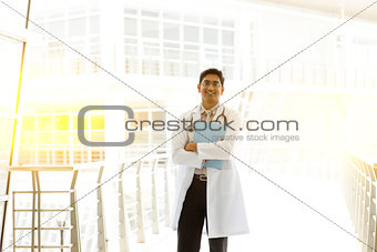 Asian Indian medical doctor holding medical report