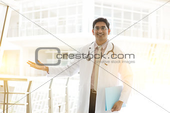 Asian Indian medical doctor welcome hand sign