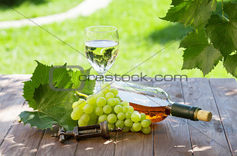 White wine bottle and glass with white grape